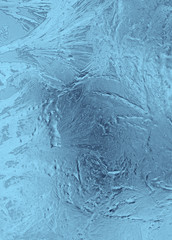 Small frosty patterns on glass in light blue tones