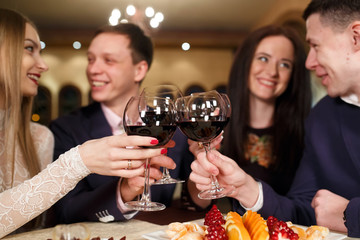 Friends at a restaurant drinking wine.