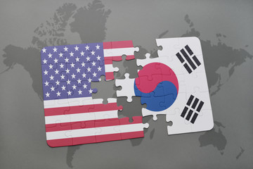 puzzle with the national flag of united states of america and south korea on a world map background