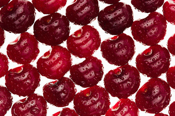 Cherry background. Ripe fresh  glossy rich cherries on white background.  Macro.  Texture. Pattern. Fruit background. Food background.