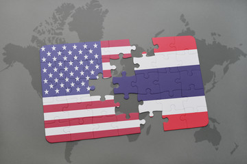 puzzle with the national flag of united states of america and thailand on a world map background