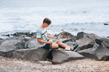 Business man working on the beach with a laptop