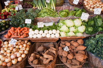 Fresh ripe vegetables on shelves in Mercado dos Lavradores, Funchal, Madeira island, Portugal.