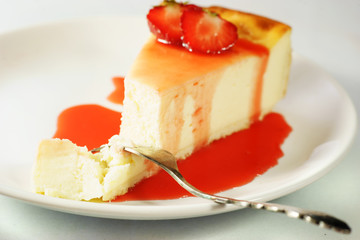 Peace of cheesecake with strawberry sauce