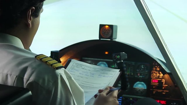 Professional pilot filling out papers before flight, getting ready to fly