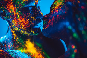 People are colored fluorescent powder. a pair of lovers dancing