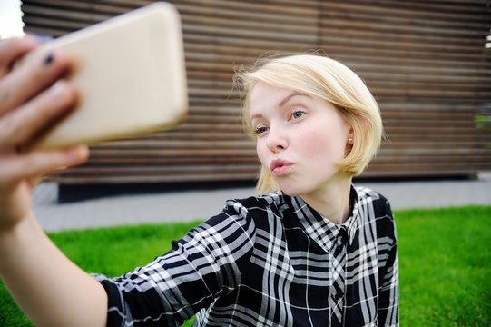 Young woman taking selfie with smart phone