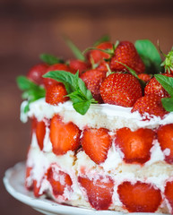 Strawberry cake on a wooden background.