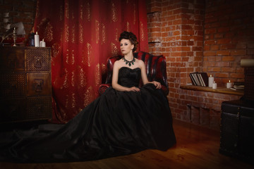 Sensual gothic woman in a long gorgeous black dress