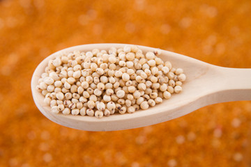 gluten free grains, millet, sorghum and linseed spoon on wooden natural background