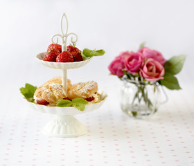 Homemade cream puffs or profiterole filled with whipped cream served with strawberries in plateau