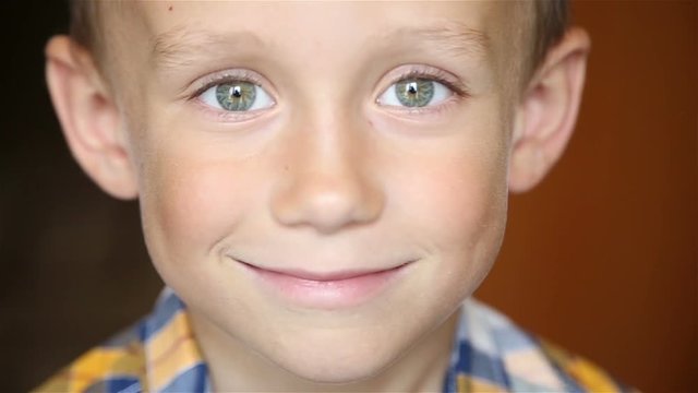 The boy looks at the camera