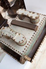 A rustic old antique leather shoe shine box.
