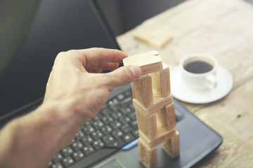 Fototapeta premium Man Hand on Wooden Blocks on Computer