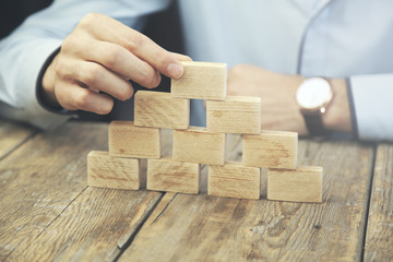 Businessman hand  wooden block