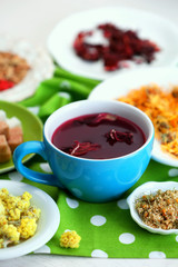Cup of tea with aromatic dry tea on wooden background