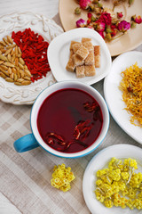 Cup of tea with aromatic dry tea on wooden background