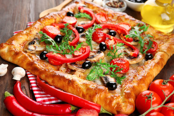 Freshly homemade pizza on wooden table closeup