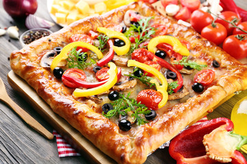 Freshly homemade pizza on wooden table closeup