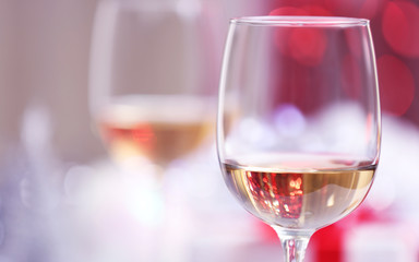 Wineglasses on blurred lights background