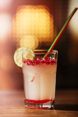 Glass of cocktail on bar background