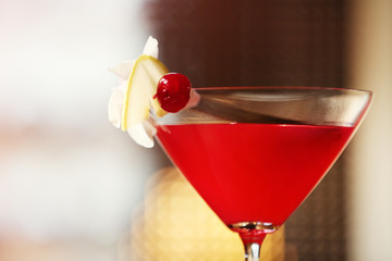 Glass of cocktail on bar background