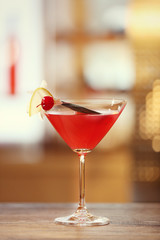 Glass of cocktail on bar background