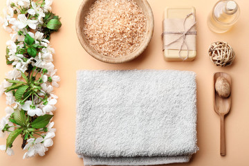 Spa treatment with blooming branch on beige background
