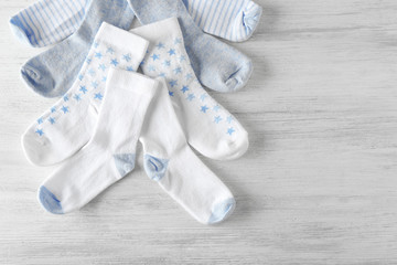 Baby socks on wooden background