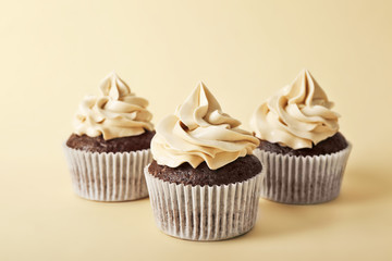 Tasty cupcakes on color background