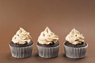 Tasty cupcakes on color background