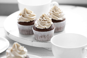 Tasty cupcakes on wooden table