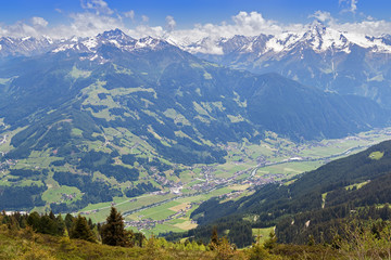 Obraz premium Bird view of the Zillertal valley village surrounded by mountains with snow during summer in Tyrol, Austria, Europe 