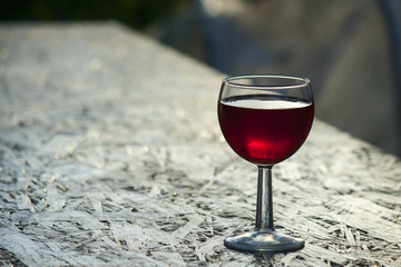bright red wine in the glass on the table