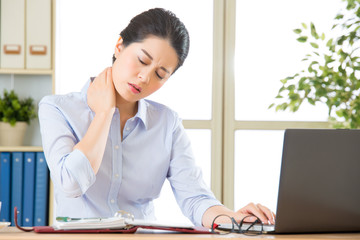 Young asian business woman with pain in neck