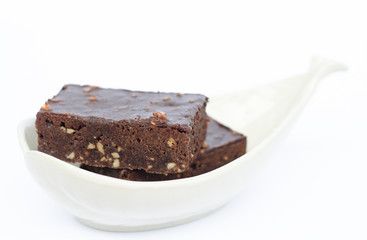 Brownie chocolate cake in white bowl isolated on white background