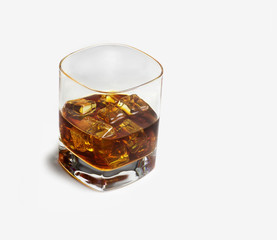 Closeup of a glass of whisky with ice cubes