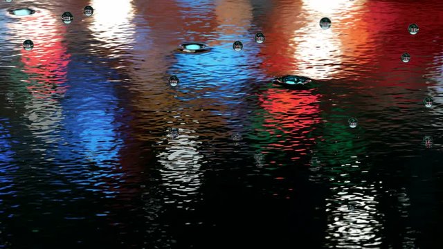 Rain hits the water surface reflecting night city lights 3D animation 