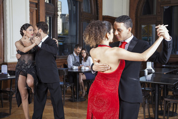 Dancers Doing Tango While Couple Dating In Restaurant