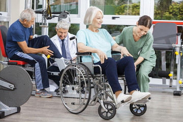 Senior People Being Assisted By Physiotherapists In Rehab Center