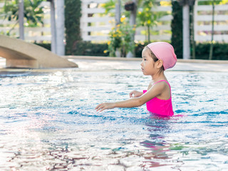 Asian girl is playing in the pool