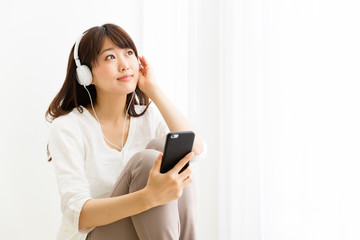 attractive asian woman listening music