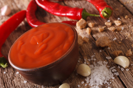 Red chilli sauce Sriracha with ingredients. horizontal, macro
