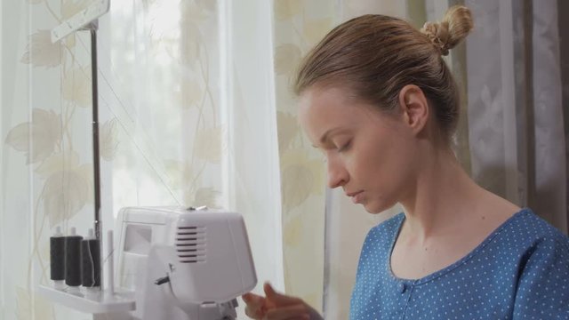 seamstresses is refilling threads and tuning an overlock