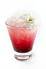 Red berries drink with chamomile in a glass isolated on white