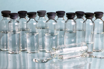 transparent vials of medicine