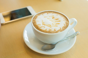 caramel macchiato coffee and mobile phone in cafe coffee