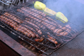 preparing sausages on fire