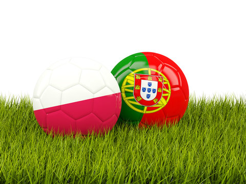 Portugal and Poland soccer  balls on grass