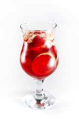 Red cocktail with fruits in a glass isolated on a white background
